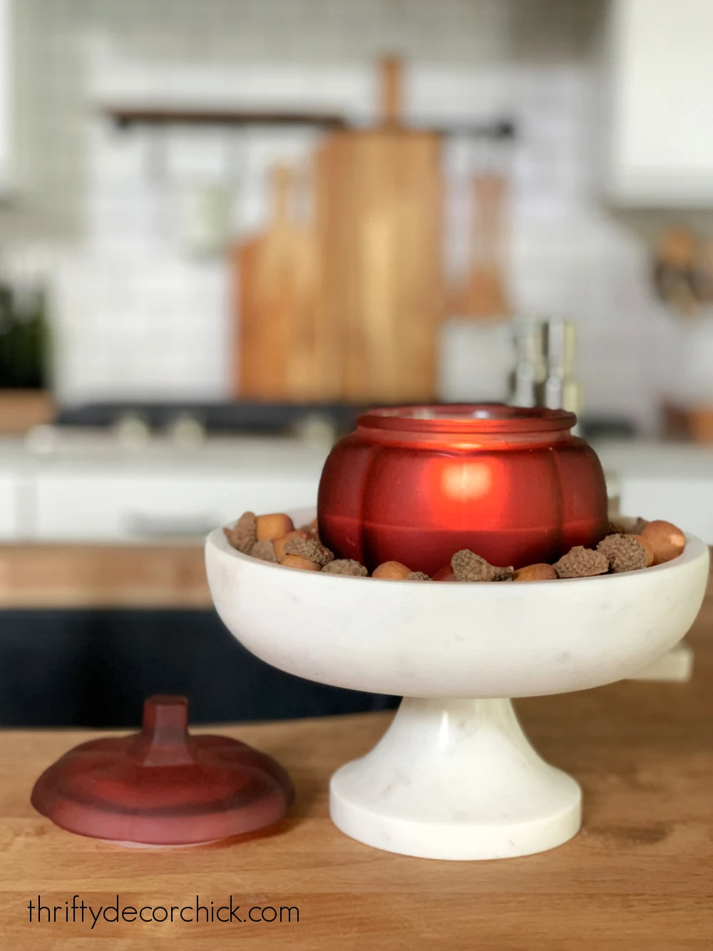 pumpkin candle in pedestal